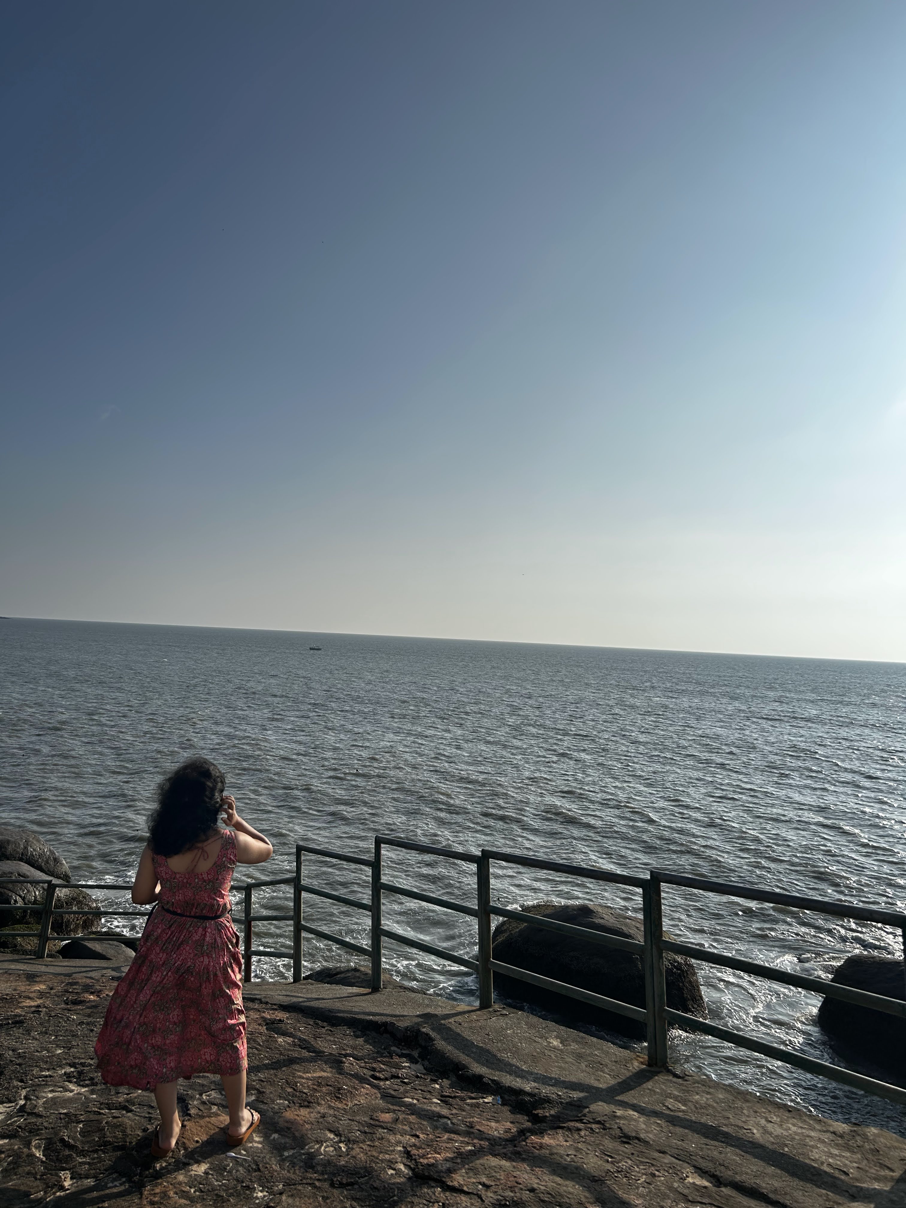 Me standing on rock by beach